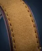 A close-up view of a watch strap made of brown leather and tan suede, with visible stitching. Podgląd zdjęcia produktu