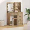 A makeup vanity with a mirror and drawers, along with a stool and a plant. Náhľad obrázku produktu