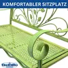 A close-up, angled view of a green metal garden bench with decorative scrollwork and leaf motifs. Podgląd zdjęcia produktu