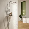 A shower system with a showerhead and handheld showerhead, a shelf with bottles, and water flowing from the showerhead. Anteprima dell’immagine prodotto