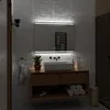 A modern bathroom vanity with a sink, mirror, and integrated LED lighting. Produktbild-Vorschau