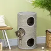 A cat is playing in a multi-level cat scratching tower in a room with light green walls. Produktbild-Vorschau