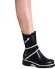 A close-up shot of a woman's lower leg wearing a black boot with a snake-like embellishment. Produktbild-Vorschau