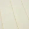 A close-up view of a cream-colored fabric with visible stitching lines. Náhľad obrázku produktu