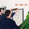 Two men are hanging a framed picture on a wall using a spirit level. Náhled obrázku produktu