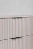 A close-up view of a beige matte cabinet with ribbed drawer fronts and black handles. Náhled obrázku produktu