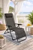 A lounge chair is set up on a wooden deck overlooking a beach and the ocean. Produktbild-Vorschau