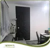 A living room or dining area with a sofa, a floor lamp, a decorative wall panel, and a dining table with chairs. Podgląd zdjęcia produktu