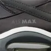 A close-up view of the side of a Nike Air Max sneaker, showing the 'AIRMAX' branding and part of the sole. Anteprima dell’immagine prodotto