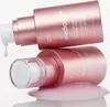Two pink pump bottles of serum, one upright with a drop falling, the other lying down in a pool of pink liquid. Produktbild-Vorschau