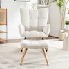A white fluffy armchair and ottoman are placed on a rug in a room. Podgląd zdjęcia produktu