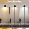 A triptych showing a floor lamp in three different light color temperatures: warm white, neutral white, and cool white. The lamp is black and modern in design, placed in a room setting with furniture visible in the background. Produktbild-Vorschau