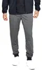 A person wearing grey sweatpants and a dark jacket. Produktbild-Vorschau