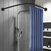 A shower curtain rod and shower head in a bathroom. Podgląd zdjęcia produktu