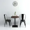 A round bistrot table with two chairs and a vase of flowers. Náhľad obrázku produktu
