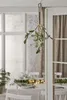 A festive indoor scene with a table set for a meal, decorated with Christmas lights and greenery. A mistletoe decoration with LED lights hangs in the foreground. Produktbild-Vorschau