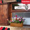 A wooden planter box filled with colorful flowers sits on a brick windowsill. Anteprima dell’immagine prodotto