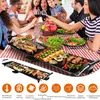 A family is enjoying a meal with a grill on a table. Produktbild-Vorschau