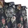 A close-up view of dark blue curtains with a floral pattern. Produktbild-Vorschau