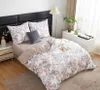 A neatly made bed with floral patterned bedding, pillows, and a bedside table with a lamp and decor. Podgląd zdjęcia produktu