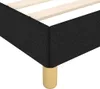 A close-up view of the corner of a black fabric bed frame with wooden slats and a single wooden leg. Náhled obrázku produktu