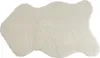 A single, irregularly shaped, beige faux sheepskin rug is shown against a white background. Produktbild-Vorschau