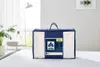 A packaged duvet is placed on a bed in a well-lit room. Produktbild-Vorschau
