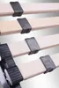 Close-up view of wooden slats with black plastic holders, likely part of a bed frame. Produktbild-Vorschau