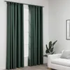 Two dark green curtains hang from a rod in front of a window. A white sofa and a potted plant are visible to the right. Podgląd zdjęcia produktu