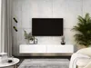 A modern living room with a wall-mounted TV and a white media console. Produktbild-Vorschau