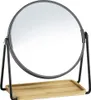 A round makeup mirror with a black metal frame and stand, featuring a small bamboo tray at the base. Podgląd zdjęcia produktu