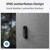 A video doorbell is mounted on a textured gray wall, with rain visible in the background and a cloud icon with rain. Produktbild-Vorschau