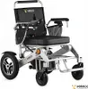 An electric wheelchair with a black seat and silver frame is shown against a white background. Náhľad obrázku produktu