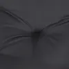 A close-up view of a black tufted cushion. Produktbild-Vorschau