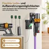 A cordless vacuum cleaner and its charging accessories are displayed against a light-colored wall and a cabinet. Produktbild-Vorschau