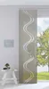 A panel curtain with a wavy pattern hangs in front of a window with a view of trees and grass.