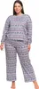 A woman is wearing a gray pajama set with a Nordic-inspired pattern. Produktbild-Vorschau