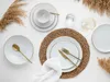 A table setting with white porcelain plates, gold cutlery, and decorative dried grass. Náhľad obrázku produktu
