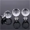 Three crystal cabinet knobs with silver bases are shown on a reflective gray surface. Produktbild-Vorschau