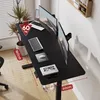 A black adjustable height desk with two monitors, a laptop, and a mouse. There is also a plant and a pair of headphones visible. Náhled obrázku produktu