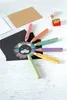 Colored pencils and a drawing of a lion on black paper. Voir les images du produit
