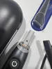 Close-up view of parts of an electric toothbrush and its accessories. Produktbild-Vorschau