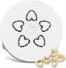 A white pasta maker accessory with heart-shaped cutouts, and several heart-shaped pasta pieces in the foreground. Produktbild-Vorschau