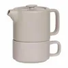A gray teapot stacked on top of a matching mug, both made of ceramic, against a white background. Podgląd zdjęcia produktu