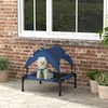 A small white dog sits on a raised pet bed with a blue canopy, placed on a patio next to a brick wall and a window. Náhľad obrázku produktu