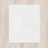 A white shower tray with a central drain cover, placed on a light wood floor. Produktbild-Vorschau