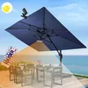 An outdoor patio scene with a table and chairs under a large navy blue umbrella, illuminated by solar lights. A remote control is shown in the foreground. Anteprima dell’immagine prodotto