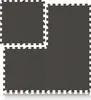 Four interlocking dark gray puzzle mats are arranged on a white surface, with a reflection visible below. Náhľad obrázku produktu