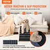 A small dog is standing on a pet ramp placed in front of a couch. The image highlights the ramp's features. Produktbild-Vorschau