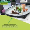 A gardening mat with soil, pots, and tools on a patio. Produktbild-Vorschau